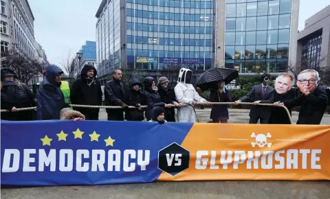  ??  ?? Protestors in Brussels demonstrat­e against the European Commission's decision for a five-year extension of a licence to sell glyphosate on November 27, 2017