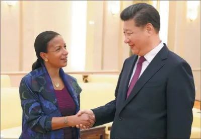  ?? WU ZHIYI / CHINA DAILY ?? President Xi Jinping greets US National Security Advisor Susan Rice during their meeting at the Great Hall of the People in Beijing on Monday. The two sides agreed to effectivel­y control their difference­s.