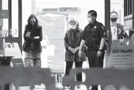  ?? DAMIAN DOVARGANES AP ?? Former Secretary of State Hillary Clinton, center, leaves the Irvine Medical Center of the University of California, where ex-President Bill Clinton has been a patient since Thursday.