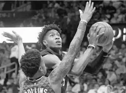  ?? JOHN AMIS/ASSOCIATED PRESS ?? The Magic’s Wesley Iwundu, who finished with 5 points in 28 minutes, shoots against Atlanta’s John Collins, who tallied 10 points and 11 rebounds in 33 minutes Sunday night.