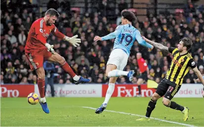  ??  ?? Midfielder Leroy Sane scores Manchester City’s first goal against Watford during their English Premier League match at Vicarage Road, Watford, on Tuesday. City won 2-1. — Reuters