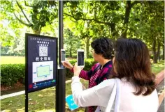  ??  ?? This photo shows people scanning a QR code to book a self-driving minibus at Shanghai Jiao Tong University in Shanghai. The bus is on a trial operation at the campus running along a fixed route with four stops. — AFP photo