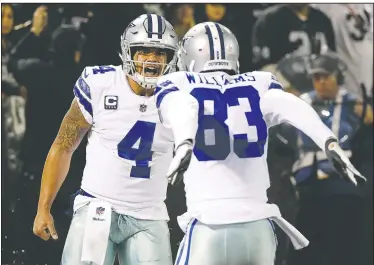  ?? AP/ERIC RISBERG ?? Dallas Cowboys quarterbac­k Dak Prescott (left) celebrates with wide receiver Terrance Williams after scoring a touchdown against the Oakland Raiders on Sunday in Oakland, Calif.