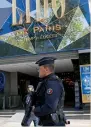  ?? — AP ?? A riot police officer patrols outside the Lido cabaret on the Champs Elysees boulevard in Paris.