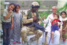  ??  ?? At war: Sitting with an Iraqi family in 2005, and right, in a 2018 ceremony