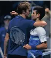  ?? MARCO BERTORELLO Reuters ?? GERMANY’S Alexander Zverev, left, and Novak Djokovic embrace after Zverev won their semi-final match of the ATP Finals in Turin in November.
|