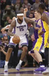  ?? Associated Press ?? Kings’ center DeMarcus Cousins, left, goes to the basket against Lakers’ center Timofey Mozgov, right, Monday, in Sacramento.