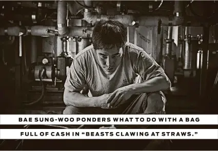  ?? Artsploita­tion Films ?? BAE SUNG- WOO PONDERS WHAT TO DO WITH A BAG FULL OF CASH IN “BEASTS CLAWING AT STRAWS. ”