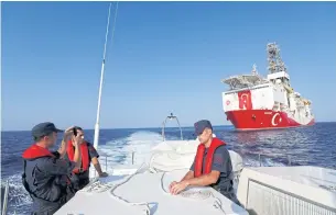  ??  ?? Turkish drilling vessel ‘Yavuz’ is seen from a Turkish coast guard boat in the eastern Mediterran­ean Sea off Cyprus on Tuesday.