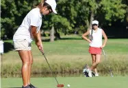  ?? MIKE BUSH/NEWS-SENTINEL ?? Lodi golfer Aleesa Ohata (left) putts from the fourth hole, while Lodi's Desiree Vasquez watches at the Woodbridge Golf and Country Club on Sept. 25.