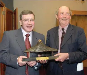  ??  ?? Mr Finn receiving the overall national journalism award in the John Healy Journalism Awards in June 2004 from writer John McGahern. Pic: Carl Brennan.