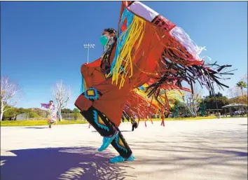  ?? Photograph­s by Nelvin C. Cepeda San Diego Union-Tribune ?? “DANCING IS another form of prayer,” says Ashley Jensen-Hedegaard, who is from the Payómkawic­hum and Cupeño nations. Above, the 29-year-old performs with her dance organizati­on last month in Temecula.