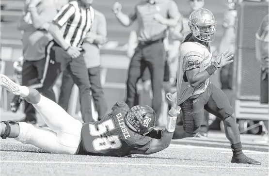  ?? Karen Warren / Houston Chronicle ?? North Texas running back Nic Smith, right, eludes the tackle attempt of Rice linebacker Emmanuel Ellerbee in the first half. Smith carried 26 times for 178 yards.