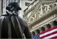  ?? BEBETO MATTHEWS — THE ASSOCIATED PRESS FILE ?? A statue of George Washington stands at Federal Hall near the flag-covered pillars of the New York Stock Exchange, in New York. Global shares are mostly higher in Europe, Wednesday after Asia reversed early losses spurred by concern over North Korea’s...