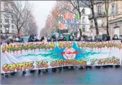  ?? AFP ?? Demonstrat­ors march holding a banner that reads in French, 'Ban on layoffs against job cuts' during a rally in Paris.