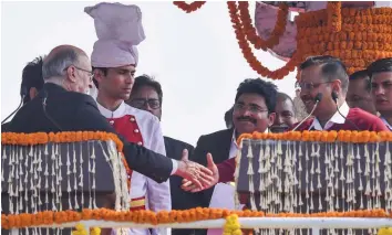  ?? — PTI ?? Delhi lieutenant-governor Anil Baijal greets AAP convenor Arvind Kejriwal after he took oath as the chief minister of Delhi for the third consecutiv­e time at a ceremony at Ramlila Maidan in New Delhi on Sunday.