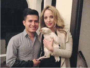  ?? DENISE RYAN ?? Jockey Mario Gutierrez poses at home in Pasadena with wife Rebecca Ayarra and their pet chicken Coco.