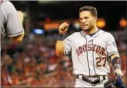  ?? THE ASSOCIATED PRESS ?? Houston Astros second baseman Jose Altuve is congratula­ted after scoring against the Minnesota Twins.