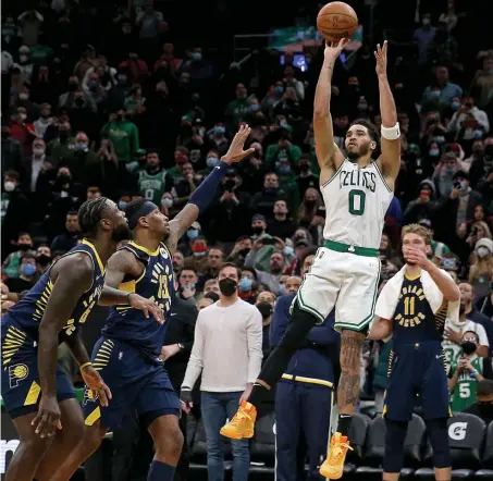  ?? ?? PLAY ON: Jayson Tatum hits a baseline jumper with 1.5 seconds left in regulation to force overtime, where the Celtics prevailed over the Indiana Pacers last night at TD Garden.