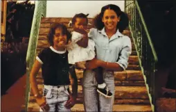  ?? COURTESY OF THE SHELTON FAMILY ?? In front of Regina Shelton’s house in Berkeley, Harris carries Shelton’s granddaugh­ter Saniyyah Smith with her sister Maya in the summer of 1978.