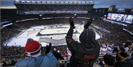  ?? CHARLES KRUPA — THE ASSOCIATED PRESS ?? Tarek Sawan, right, and Alexandra Desbiens celebrate a goal by Montreal’s Max Pacioretty during the third period of the NHL Winter Classic against the Boston Bruins at Gillette Stadium in Foxborough, Mass., Friday. The Canadiens won 5-1.