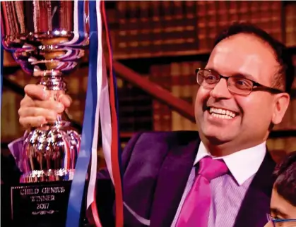  ??  ?? Taking the limelight: Minesh Doshi holds up the trophy his son won on TV show Child Genius