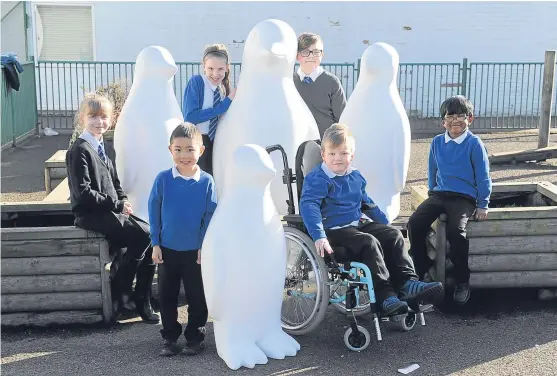  ?? Picture: Kim Cessford. ?? Pupils at Our Lady’s RC Primary got a chance to meet their penguins yesterday when they waddled into their school.