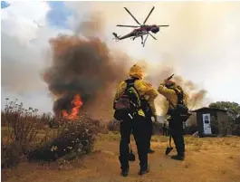  ?? K.C. ALFRED U-T ?? A helicopter makes a drop near Montiel Truck Trail during the Valley Fire near Alpine on Sept. 6. The state has seen a huge increase in wildfires in recent years.