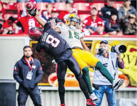  ?? AL CHAREST ?? Stampeders defender Emanuel Davis knocks the ball loose with a big hit on Eskimos receiver Vidal Hazelton during the Labour Day Classic on Monday. The Stamps won 23-20.