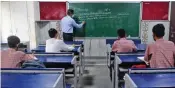  ?? — G.N JHA, PTI ?? (Left) Students attend a class at Sarvodaya Bal Vidyalaya in Rouse Avenue that reopened after further ease in Covid-19 restrictio­ns in New Delhi on Wednesday. Students in a classroom at Rajkiya Sarvodaya Bal Vidyalaya.