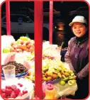  ??  ?? Vendor selling a variety of fruits on the sidewalk