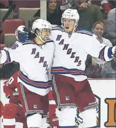  ?? Gregory Shamus/Getty Images ?? J.T. Miller, right, celebrates his winning goal in overtime with teammate Mats Zuccarello as the New York Rangers defeated the Detroit Red Wings, 1-0, in Detroit.