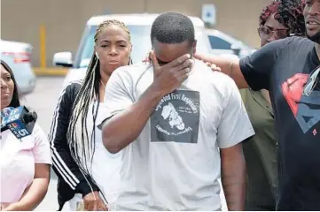  ??  ?? Charles McKenzie becomes emotional during a prayer circle Friday, a day after a mass shooting took place nearby, in which his niece was critically injured.