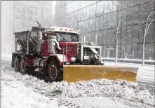  ?? SCOTT EISEN / GETTY IMAGES ?? A snow plow clears a road as Winter Storm Skylar bears down on Boston on Tuesday, delivering up to 2 feet of snow. This is the third nor’easter to hit in less than two weeks. Power outages are not quite as widespread.