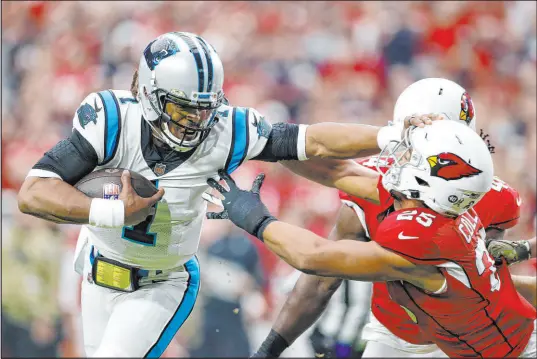  ?? Ralph Freso The Associated Press ?? Carolina Panthers quarterbac­k Cam Newton stiff-arms Arizona Cardinals lineback Zaven Collins on his way to the end zone during Sunday’s game at State Farm Stadium in Glendale, Ariz. The Panthers won 34-10.