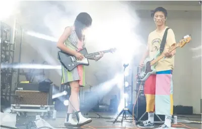  ?? TRENT SPRAGUE/ CHICAGO TRIBUNE PHOTOS ?? Lucia de la Garza, guitarist for The Linda Lindas, left, and Eloise Wong, the group’s bassist, perform during Day 3 of Lollapaloo­za on Saturday.