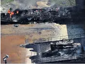  ??  ?? Left: people living within a mile and a half of the Arkema chemical plant fire in Crosby, Texas were told to evacuate because of the noxious fumes. Right: residents wade with their belongings through flood waters in northwest Houston