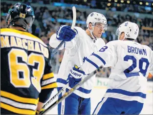  ?? AP PHOTO ?? Toronto Maple Leafs’ Connor Brown (28) celebrates his goal with teammate Auston Matthews as Boston Bruins’ Brad Marchand (63) looks on during the first period of Game 5 of an NHL first-round playoff series in Boston Saturday The Maple Leafs won 4-3.