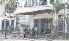  ?? REUTERS ?? Police and soldiers stand outside a bomb-hit church in Jolo, on the southern Philippine island of Mindanao in this Jan 27, 2019 file photo.