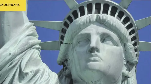  ?? TIMOTHY CLARY / AFP / GETTY IMAGES ?? The Statue of Liberty has been interprete­d as a welcome to immigrants, though that was not its original symbolic purpose.