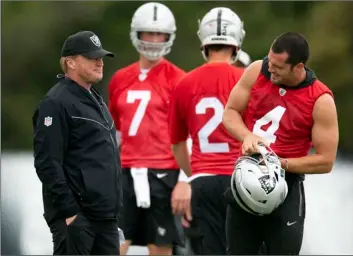  ?? AP PHOTO/D. ROSS CAMERON ?? Oakland Raiders head coach Jon Gruen (left) confers with his quarterbac­ks Mike Glennon (7), Landry Jones (2) and Derek Carr (4) during an NFL football official team activity, on Tuesday at team headquarte­rs in Alameda, Calif.