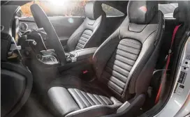  ??  ?? The performanc­e coupe’s standard sport-type seats are upholstere­d in MB-Tex, a man-made leather, and microfiber. The seat belts, floor-mat edging and topstitchi­ng are red to provide contrast.