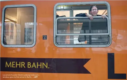  ?? — AFP ?? Locomore founder Derek Ladewig looks out a window upon its first arrival in Berlin.