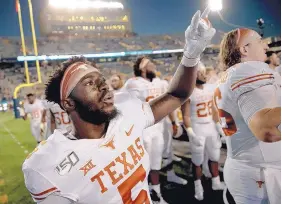  ?? NICK WAGER/AUSTIN AMERICAN-STATESMAN VIA ASSOCIATED PRESS ?? Texas defensive back D’Shawn Jamison (5) holds up the “Hook ‘Em Horns” gesture after the Longhorns beat West Virginia last Saturday.