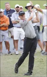  ?? The Associated Press ?? Mackenzie Hughes of Dundas, Ont., hits from the 18th tee during the first round of The Players Championsh­ip golf tournament Thursday in Ponte Vedra Beach, Fla. Hughes is tied for the lead after a 5-under 67.