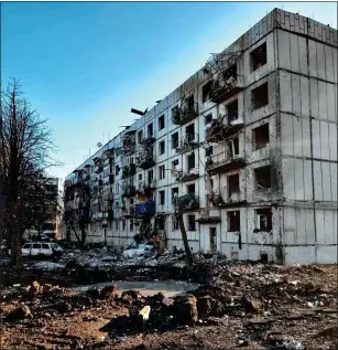  ?? ?? deSTRoYed: Olena’s apartment block, and the huge crater left by the missile