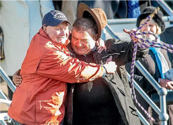  ??  ?? Three Star Syndicate member Michael ‘‘Moon’’ Prince celebrates with Miss Three Stars’ trainer Tommy Beckett.