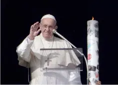  ??  ?? Pope Francis lights a candle for aid and solidarity for the people of Syria during his Sunday Angelus prayer. — AFP photo