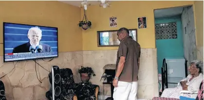  ?? REUTERS ?? People in Havana, Cuba, watch a television broadcast showing Joe Biden speaking after being sworn in as the 46th president of the United States on Jan. 20.