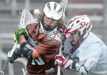  ?? TIM MARTIN/THE DAY ?? Stonington’s Jake Mueller, left, loses control of the ball after being checked by East Lyme’s Sean Williams during Tuesday night’s ECC semifinal boys’ lacrosse game at Montville. East Lyme advanced with a 17-7 win.